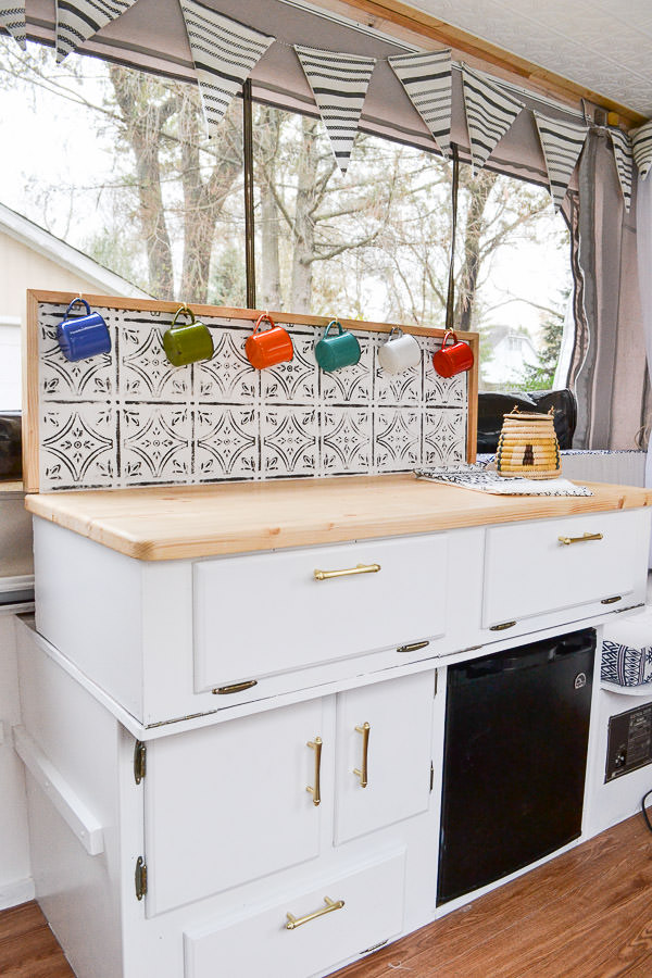 This camper is full of DIY projects - you'd never believe how it looked before. Pop up camper remodel with an eclectic vintage boho feel via Refresh Living.