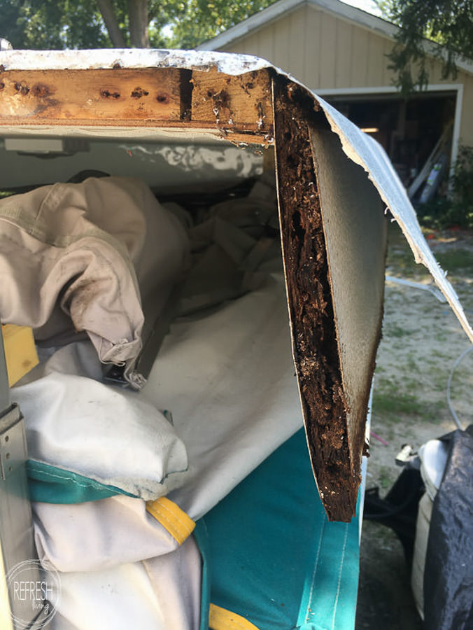 pop up camper with water damage to the wood on sides and top