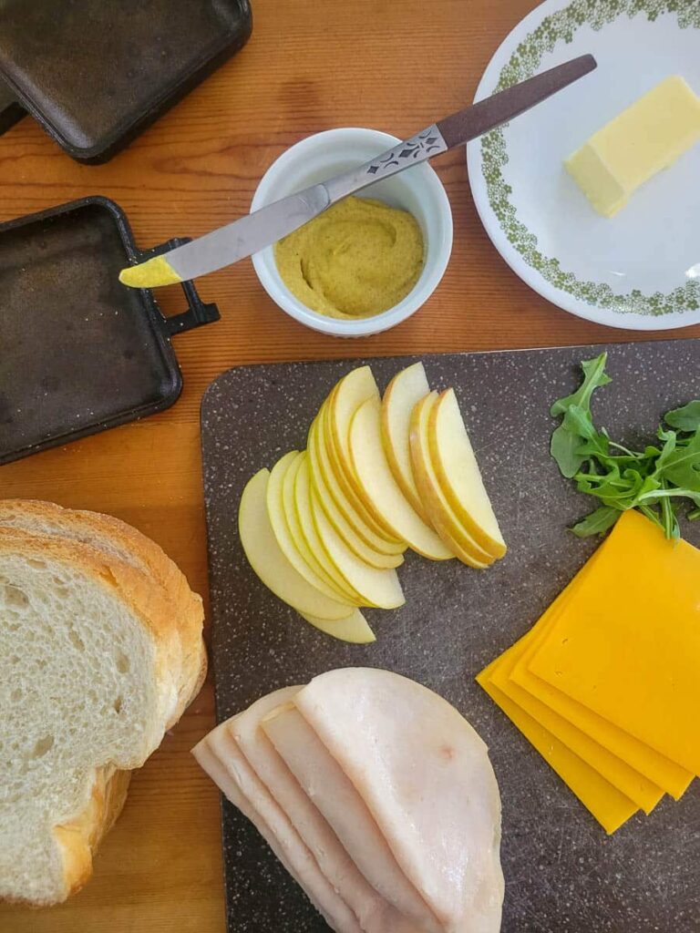 https://refreshcamping.com/wp-content/uploads/2023/03/pie-iron-recipe-turkey-cheese-apple-grilled-cheese-hobo-pie-3-768x1024.jpg