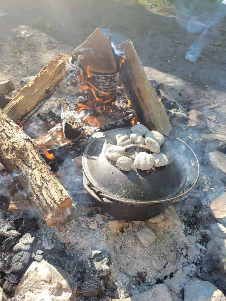 cast iron dutch oven camping over coals