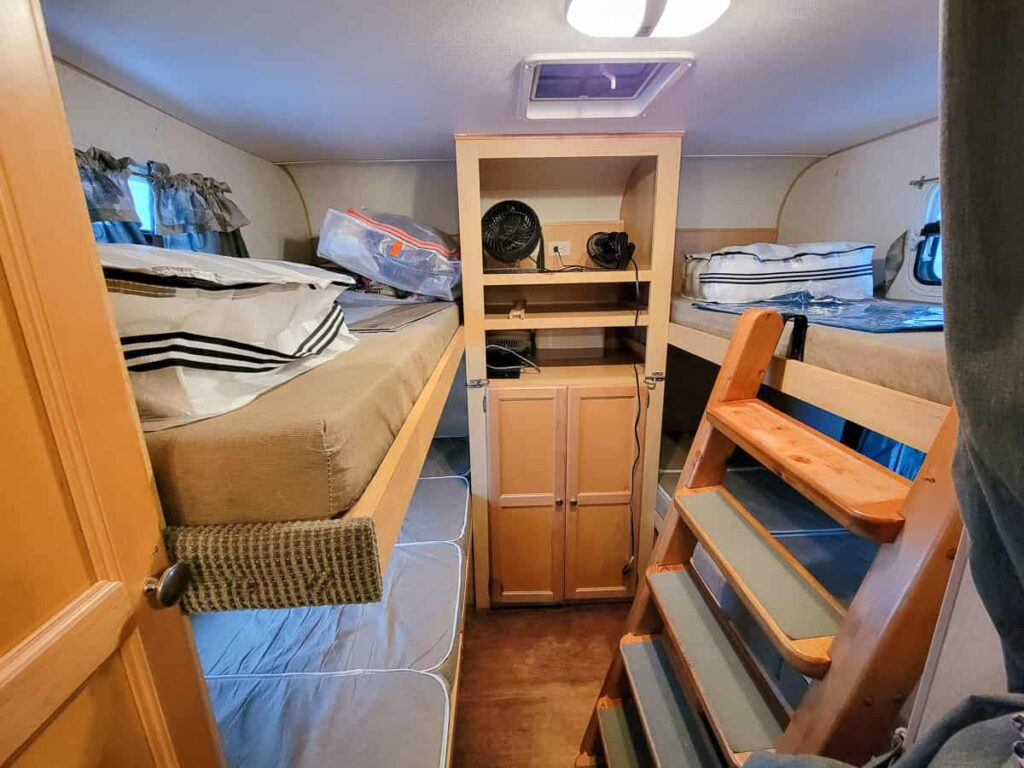 hybrid camper with four bunk beds in the back for kids