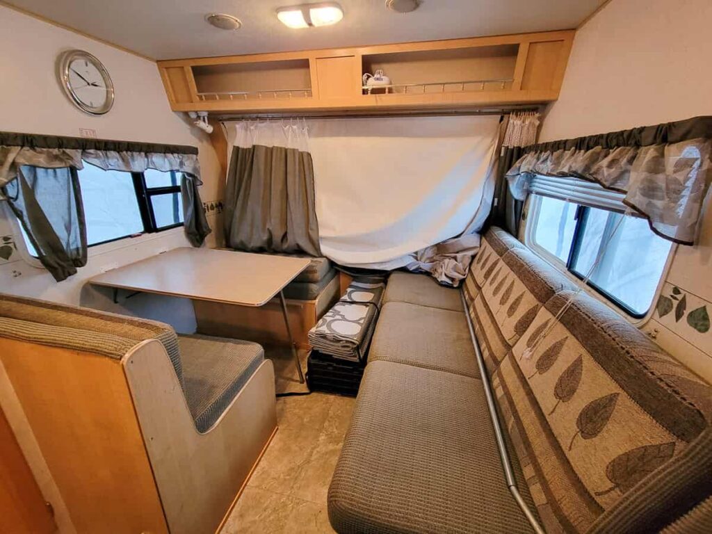 inside of hybrid camper 2006 with table and sofa couch