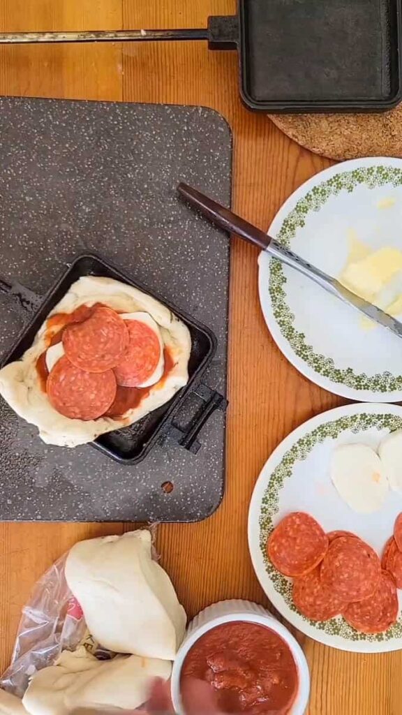 use a pie iron to make pizza while camping