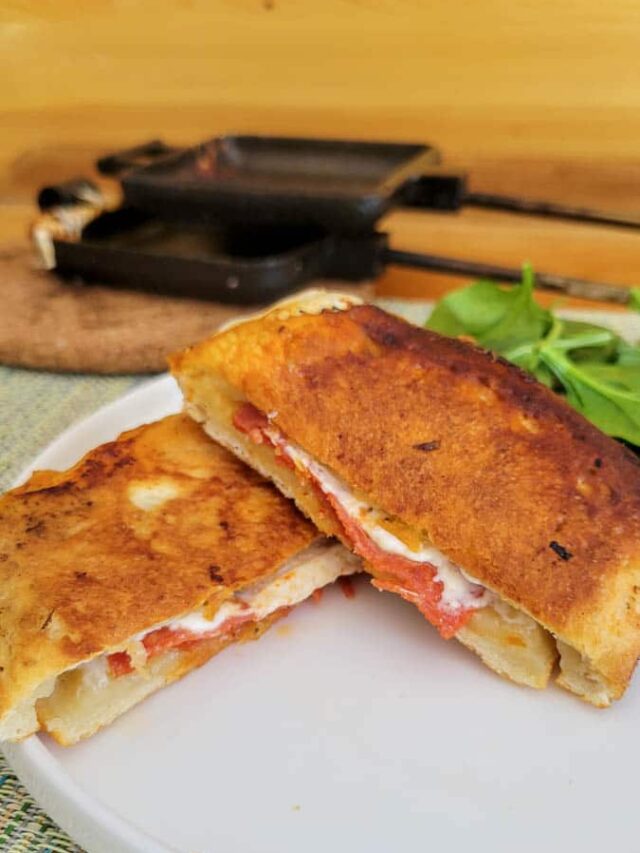 pie iron pizza pockets cooked over campfire as a hobo pie