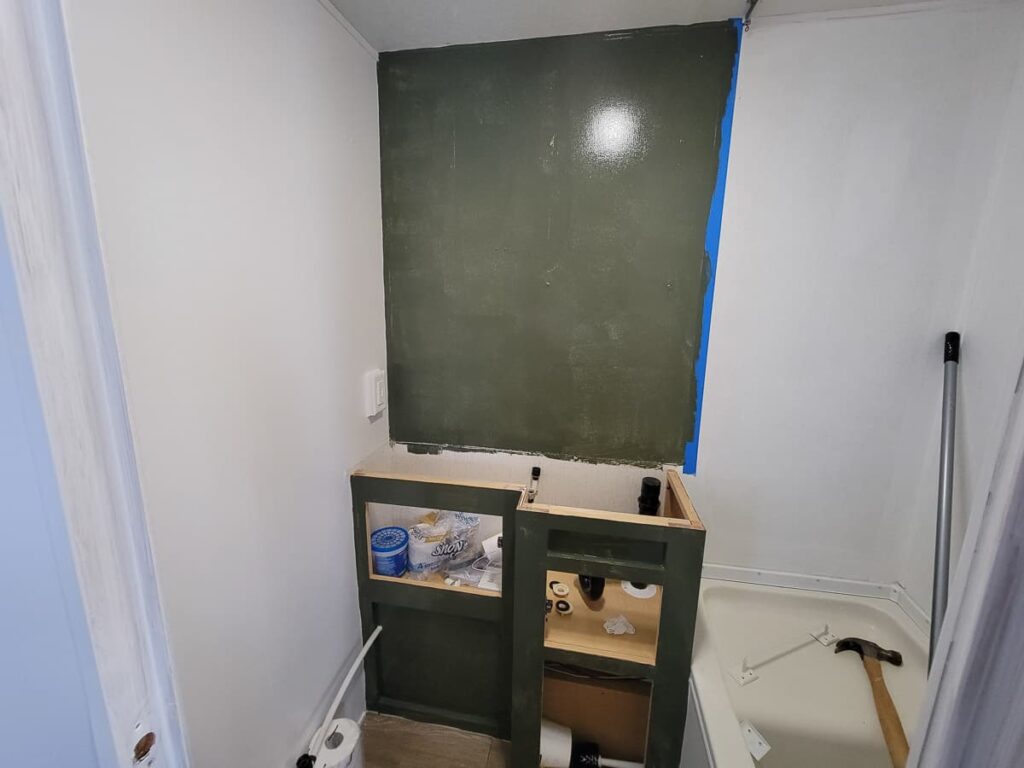 green wall and cabinet in rv bathroom remodel