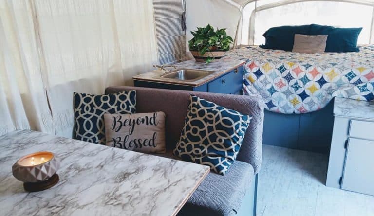 diy camper remodel with blue cabinets, contact paper marble countertops and quilt