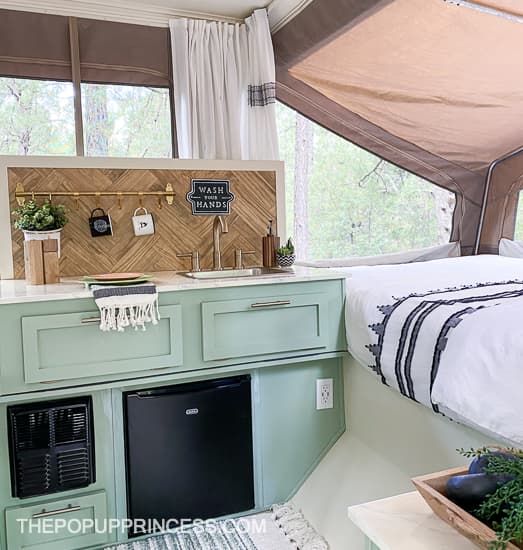 camper remodel with santa fe touches with light blue or teal cabinets and wood backsplash in pop up