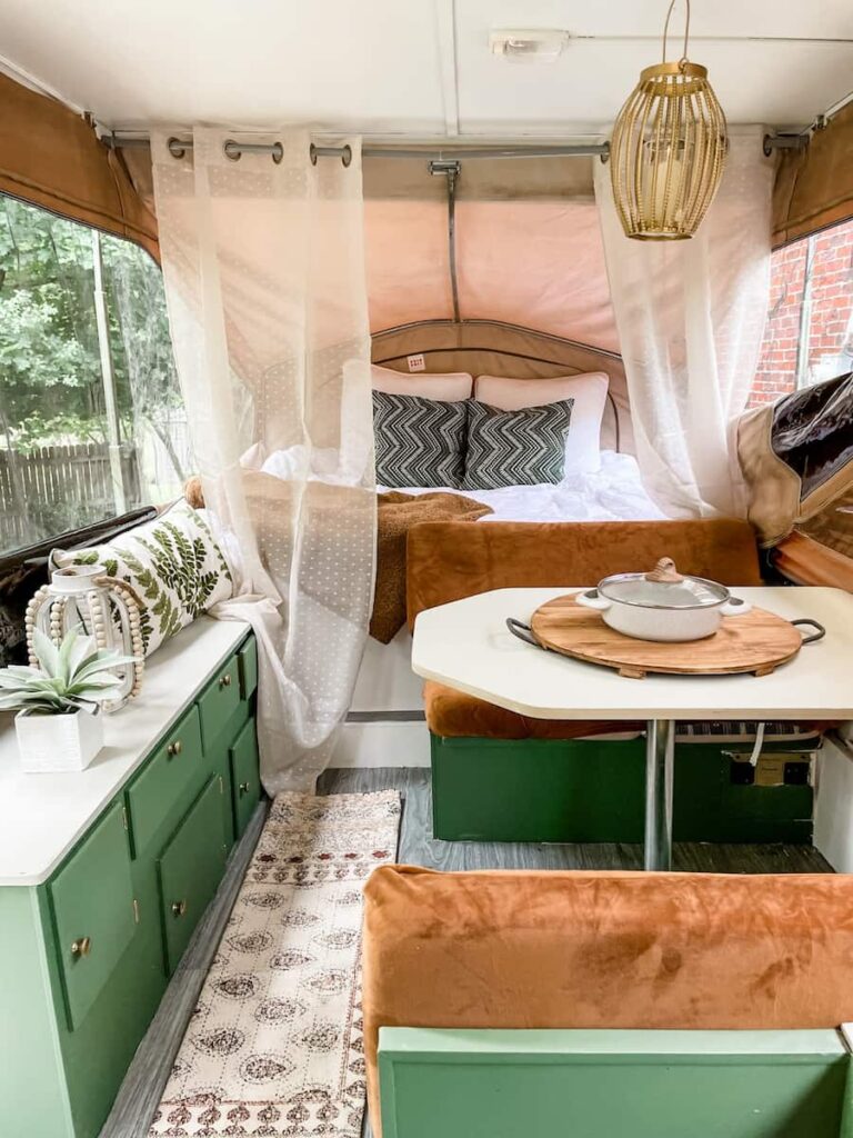 boho style pop up camper makeover with green cabinets and leather look cushions