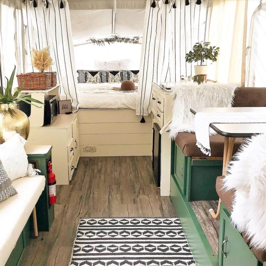 pop up camper with green and white cabinets and light modern feel