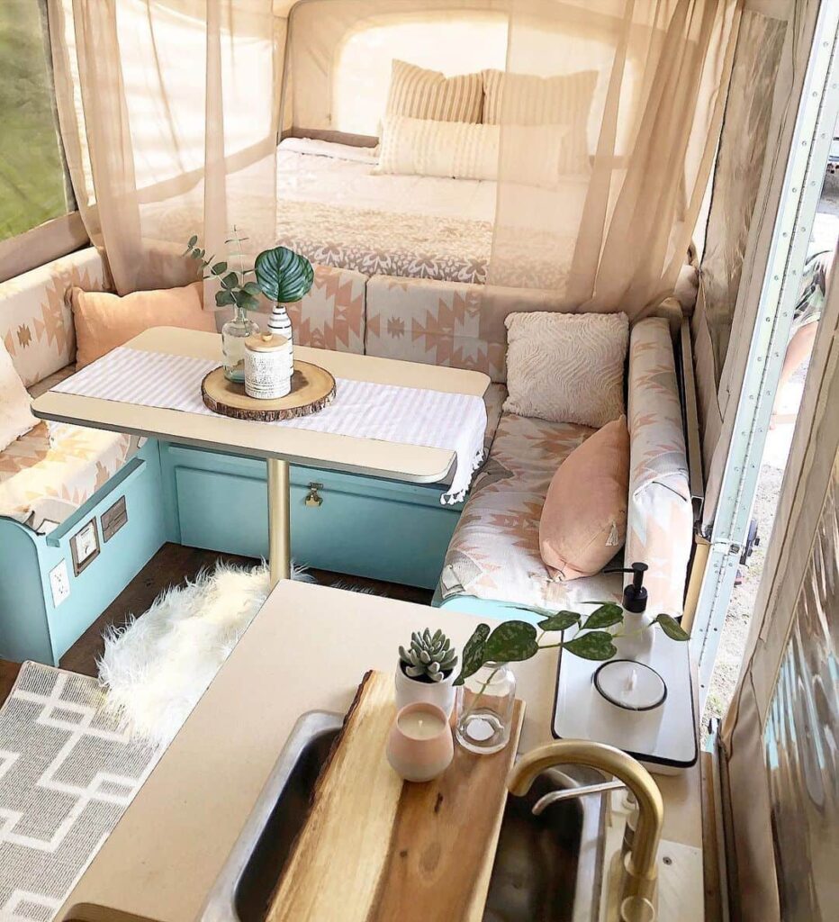 turquoise cabinets in pop up camper with aztec pattern cushions and pink taupe 
