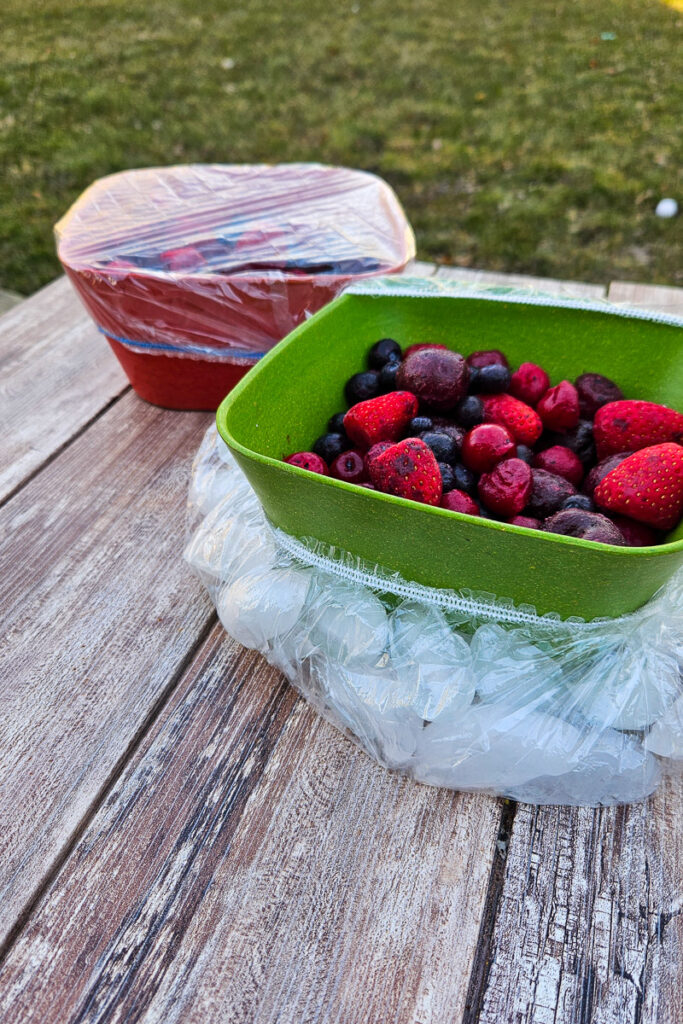 camping hack to use shower caps or bowl covers to make ice trays to keep food colder when serving