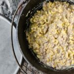 one pot camping dinner recipe in dutch oven cheeseburger casserole with beef, macaroni and cheese