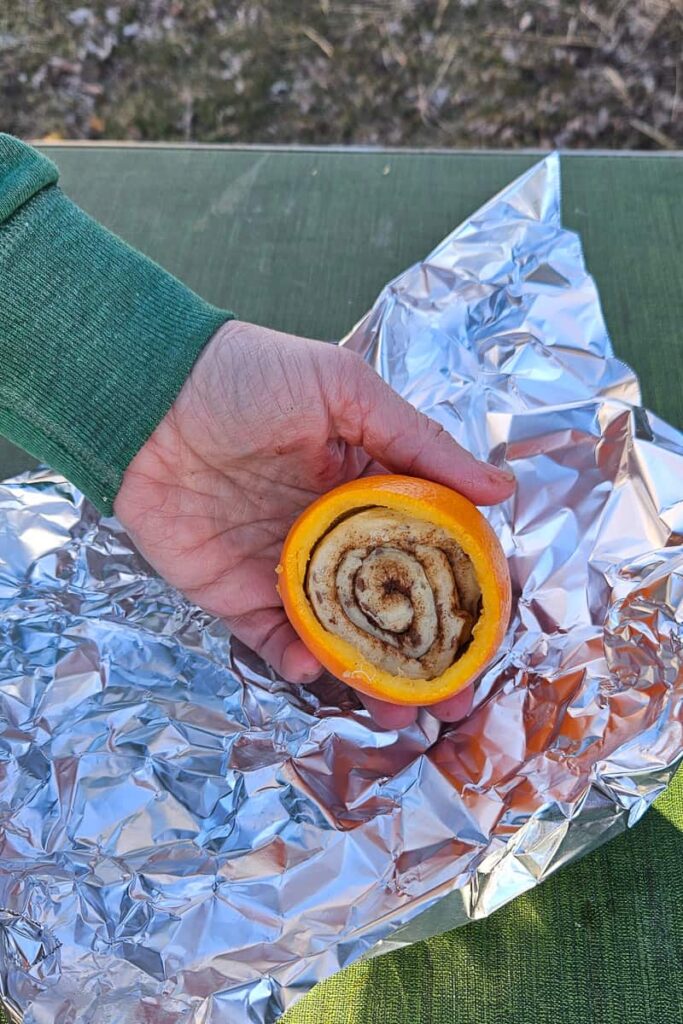how to make camping cinnamon rolls in an orange peel over the campfire