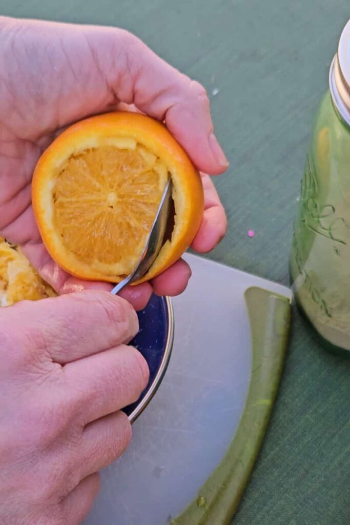 scoop out the inside of an orange to make campfire orange cakes while camping