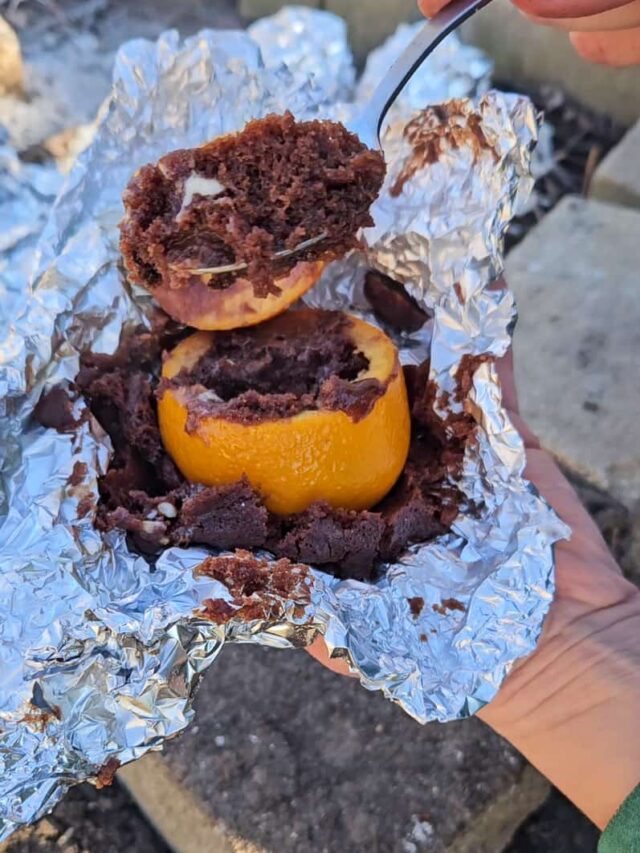 easy camping dessert hack to make cake, muffins and brownies in an orange over the campfire