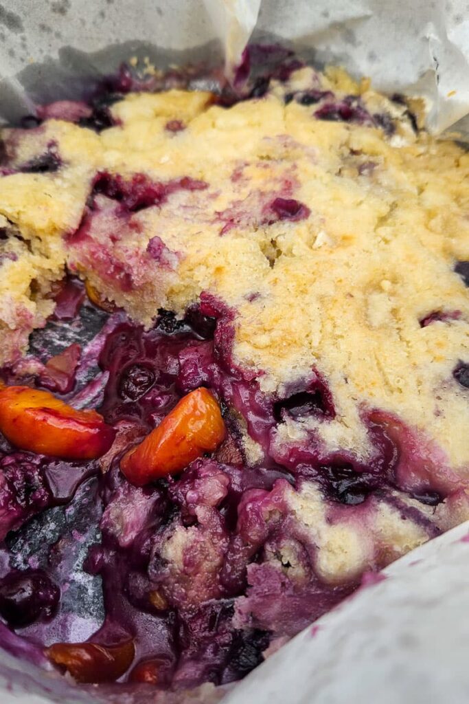 blueberries and peaches in dutch oven camping dessert