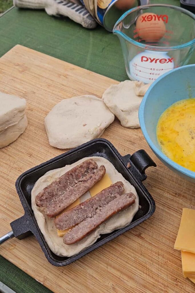 steps to make pie iron sausage egg biscuit camping recipe