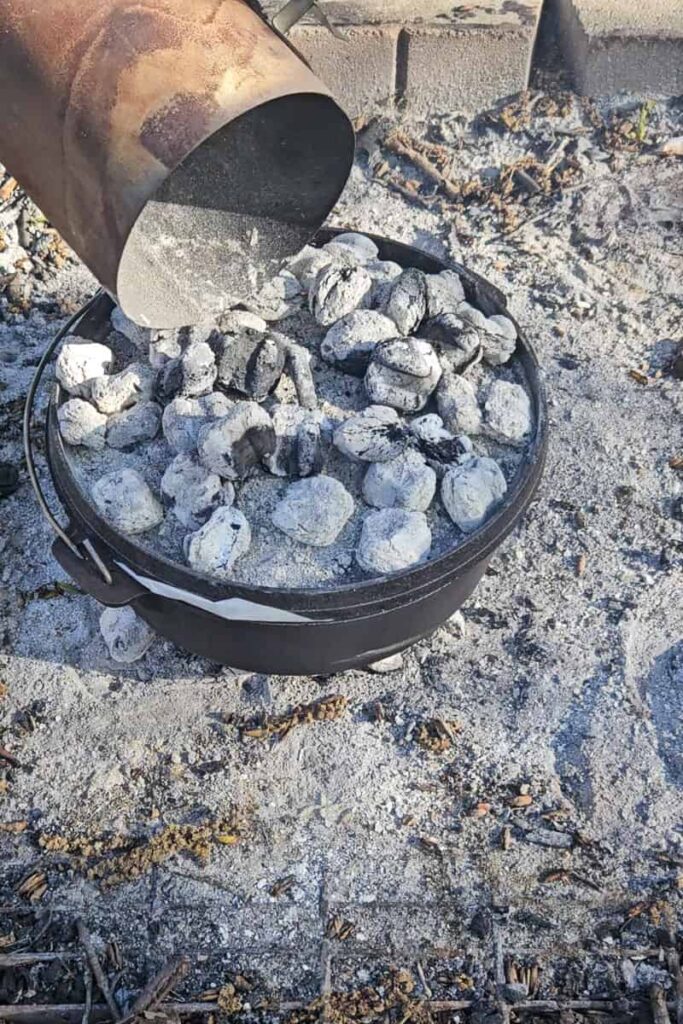 add coals on top of dutch oven to act as an oven and brown cheese on top