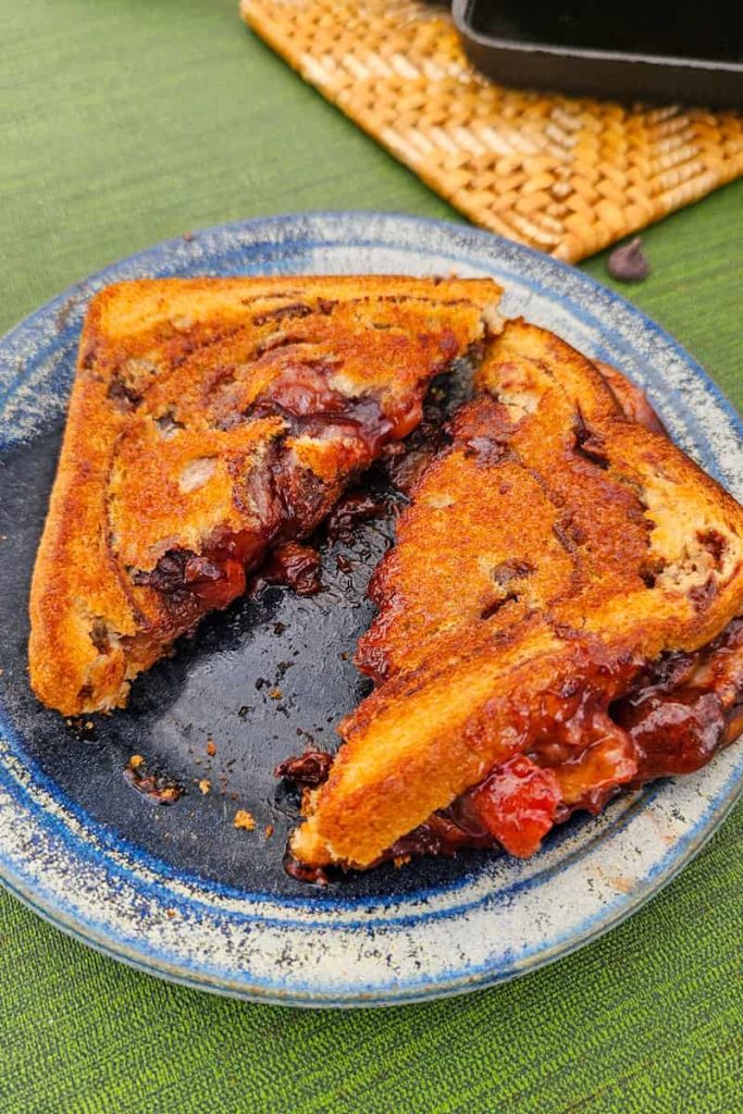 This cherry chocolate pudgy pie cooks up over the campfire in a pie iron and is so easy to make.
