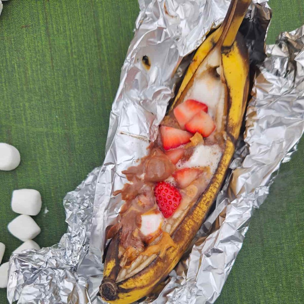 peanut butter, jelly, strawberries and marshmallows in banana boat for camping