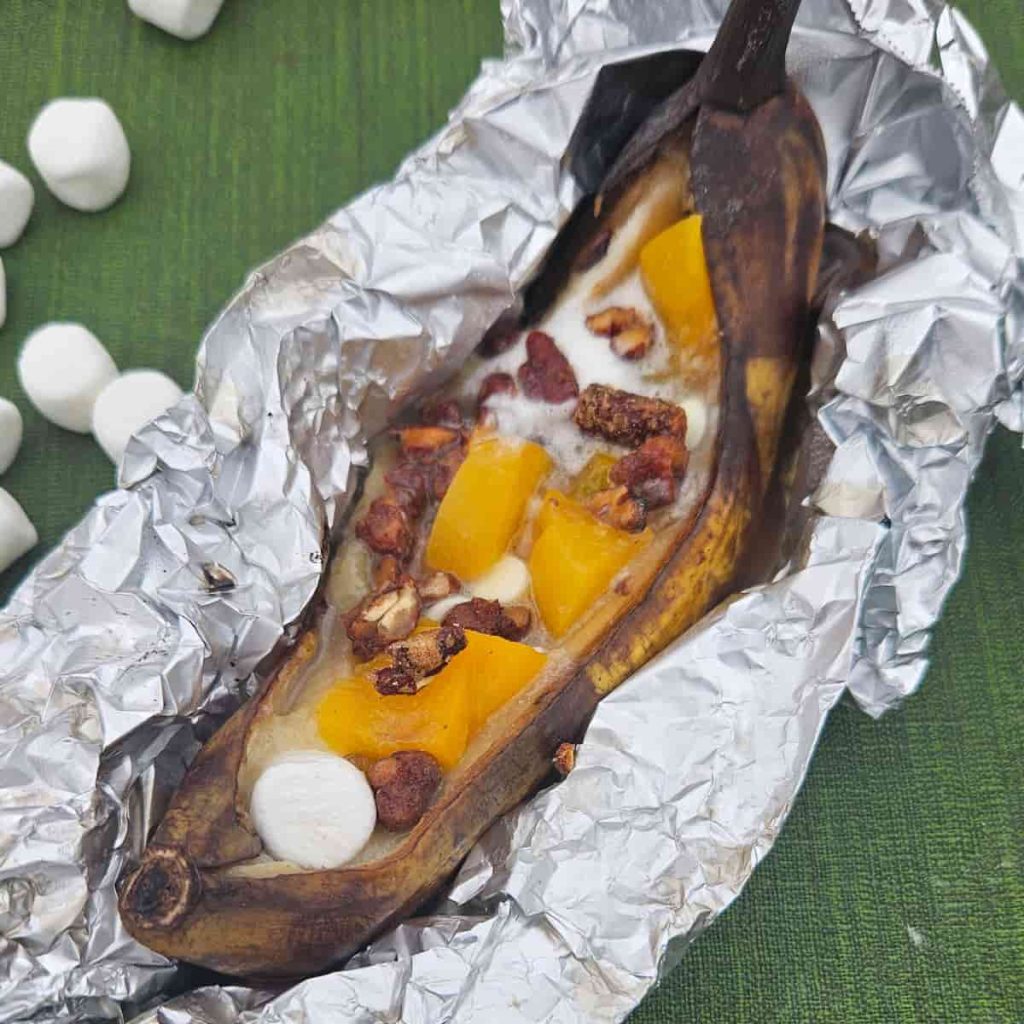 peaches, pecans and marshmallow in grilled banana boats