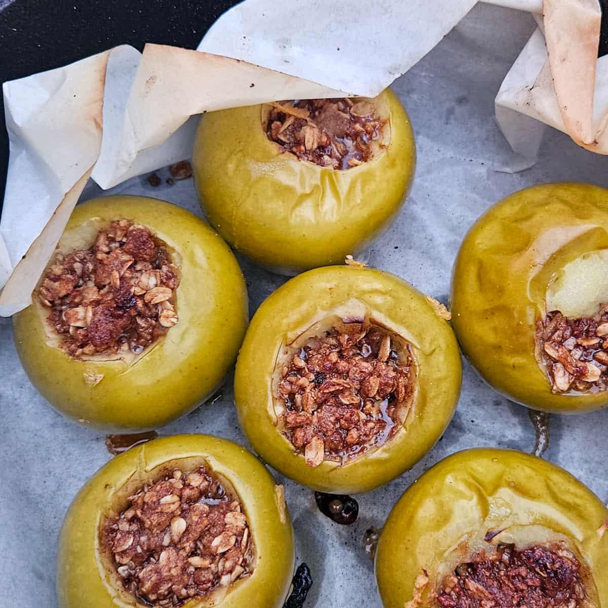 campfire apples with oats, cinnamon and pecans cooked in a dutch oven for healthy camping dessert